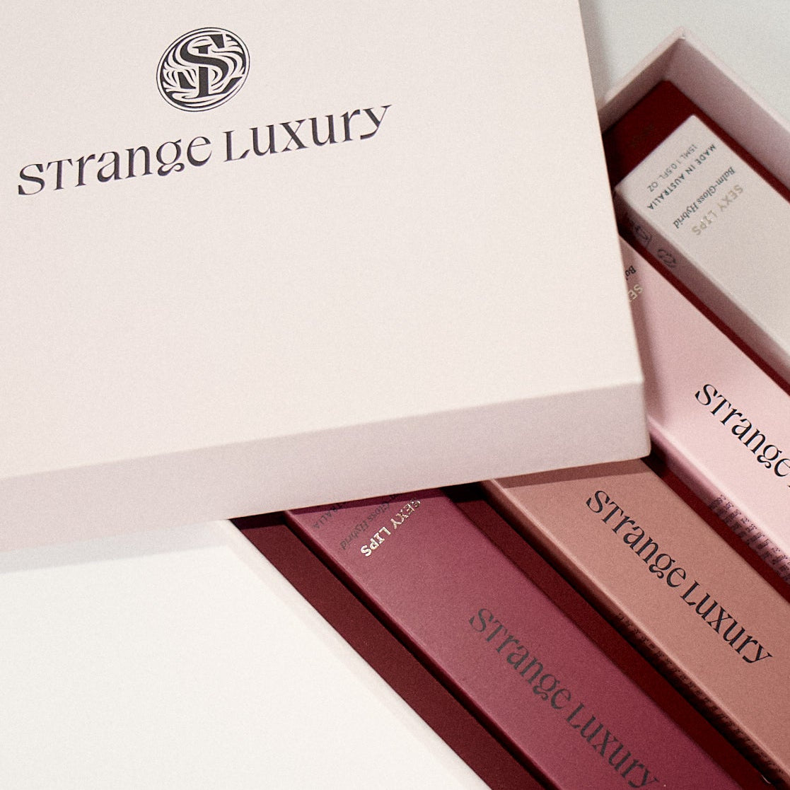 Strange Luxury lipsticks in a box on a light background.