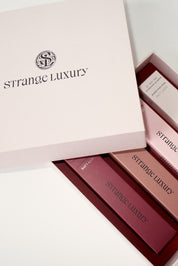 Strange Luxury lipsticks in a box on a light background.
