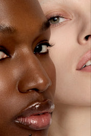 Close-up of two people with different skin tones.